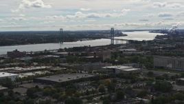 5.7K aerial stock footage of the Ambassador Bridge across the Detroit River, Detroit, Michigan Aerial Stock Footage | DX0002_190_007