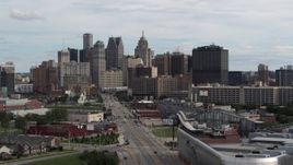 5.7K aerial stock footage descend by Grand River Avenue, view of the city's skyline, Downtown Detroit, Michigan Aerial Stock Footage | DX0002_190_032