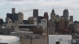5.7K aerial stock footage ascend over rooftops for view of the city's skyline, Downtown Detroit, Michigan Aerial Stock Footage | DX0002_190_035