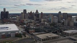 5.7K aerial stock footage flying by Comerica Park with view of skyline, reveal Ford Field, Downtown Detroit, Michigan Aerial Stock Footage | DX0002_191_009