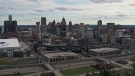 5.7K aerial stock footage a reverse view of Comerica Park baseball stadium and skyline, Downtown Detroit, Michigan Aerial Stock Footage | DX0002_191_013