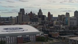 5.7K aerial stock footage of the downtown skyline while passing by baseball and football stadiums, Downtown Detroit, Michigan Aerial Stock Footage | DX0002_191_022
