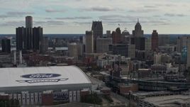 5.7K aerial stock footage focus on the downtown skyline while flying by Comerica Park and Ford Field, Downtown Detroit, Michigan Aerial Stock Footage | DX0002_191_025