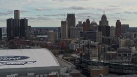 5.7K aerial stock footage focus on downtown skyline while passing Ford Field and Comerica Park, Downtown Detroit, Michigan Aerial Stock Footage | DX0002_191_026