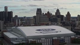 5.7K aerial stock footage focus on downtown skyline and descend by Ford Field, Downtown Detroit, Michigan Aerial Stock Footage | DX0002_191_028