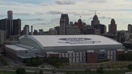 5.7K aerial stock footage focus on downtown skyline while ascending past Ford Field, Downtown Detroit, Michigan Aerial Stock Footage | DX0002_191_029