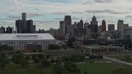 5.7K aerial stock footage flying away from stadiums with view of the skyline in Downtown Detroit, Michigan Aerial Stock Footage | DX0002_191_033