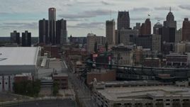 5.7K aerial stock footage descend past stadiums, focus on the skyline in Downtown Detroit, Michigan Aerial Stock Footage | DX0002_191_035