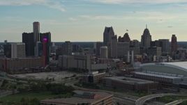 5.7K aerial stock footage fly away from the skyline at sunset in Downtown Detroit, Michigan, reveal Ford Field Aerial Stock Footage | DX0002_191_037