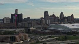 5.7K aerial stock footage passing the football stadium, focus on the city skyline at sunset in Downtown Detroit, Michigan Aerial Stock Footage | DX0002_191_039