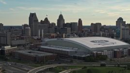 5.7K aerial stock footage of the football stadium and the city skyline at sunset in Downtown Detroit, Michigan Aerial Stock Footage | DX0002_191_040