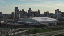 5.7K aerial stock footage of a reverse view of the football stadium and the city skyline at sunset in Downtown Detroit, Michigan Aerial Stock Footage | DX0002_191_041