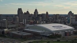 5.7K aerial stock footage of slowly passing the football stadium and the city skyline at sunset in Downtown Detroit, Michigan Aerial Stock Footage | DX0002_191_043