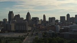 5.7K aerial stock footage of flying by the city skyline at sunset in Downtown Detroit, Michigan Aerial Stock Footage | DX0002_192_004