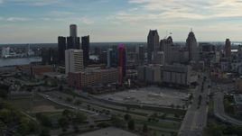 5.7K aerial stock footage a reverse view of tall skyscrapers behind a hotel at sunset, Downtown Detroit, Michigan Aerial Stock Footage | DX0002_192_007