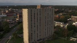 5.7K aerial stock footage an orbit of the City Place Detroit apartment building at sunset, Detroit, Michigan Aerial Stock Footage | DX0002_192_011