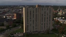 5.7K aerial stock footage slowly orbit the City Place Detroit apartment building at sunset, Detroit, Michigan Aerial Stock Footage | DX0002_192_012