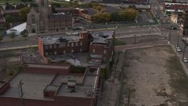 5.7K aerial stock footage orbit around an abandoned building at sunset, Detroit, Michigan Aerial Stock Footage | DX0002_192_016