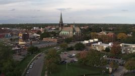 5.7K aerial stock footage of flying away from and by a church at sunset, Detroit, Michigan Aerial Stock Footage | DX0002_192_018