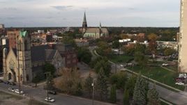 5.7K aerial stock footage of a reverse view of a church from a second church at sunset, Detroit, Michigan Aerial Stock Footage | DX0002_192_020