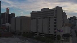 5.7K aerial stock footage descend and fly away from Frank Murphy Hall of Justice at sunset, Downtown Detroit, Michigan Aerial Stock Footage | DX0002_192_027