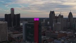 5.7K aerial stock footage of flying by a hotel, skyscrapers in the background at sunset, Downtown Detroit, Michigan Aerial Stock Footage | DX0002_192_034