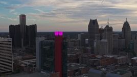 5.7K aerial stock footage of passing by a hotel to focus on skyscrapers at sunset, Downtown Detroit, Michigan Aerial Stock Footage | DX0002_192_035