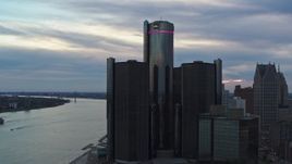 5.7K aerial stock footage orbit and fly away from riverfront skyscraper at sunset, Downtown Detroit, Michigan Aerial Stock Footage | DX0002_192_040