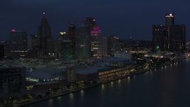 5.7K aerial stock footage focus on skyscrapers while flying by convention center at twilight, Downtown Detroit, Michigan Aerial Stock Footage | DX0002_193_006