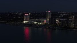 5.7K aerial stock footage of Caesar Windsor hotel and casino across the river at night, Windsor, Ontario, Canada Aerial Stock Footage | DX0002_193_011