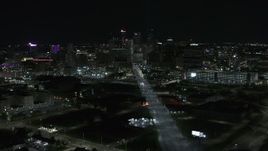 5.7K aerial stock footage the city's skyline at night while passing Grand River Avenue, Downtown Detroit, Michigan Aerial Stock Footage | DX0002_193_023