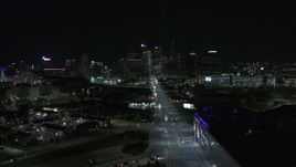 5.7K aerial stock footage flying by Grand River Avenue, focus on skyline at night, Downtown Detroit, Michigan Aerial Stock Footage | DX0002_193_026