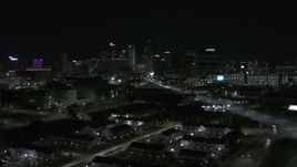 5.7K aerial stock footage flying by the skyline at night and descend, Downtown Detroit, Michigan Aerial Stock Footage | DX0002_193_027
