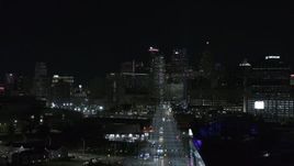 5.7K aerial stock footage of the skyline at night during descent over Grand River Avenue, Downtown Detroit, Michigan Aerial Stock Footage | DX0002_193_032