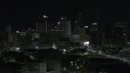 5.7K aerial stock footage focus on skyline at night while descending, Downtown Detroit, Michigan Aerial Stock Footage | DX0002_193_034
