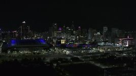 5.7K aerial stock footage the skyline behind Ford Field and Comerica Park stadiums at night, Downtown Detroit, Michigan Aerial Stock Footage | DX0002_193_047