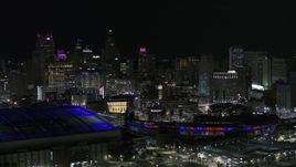 5.7K aerial stock footage flyby sports stadiums and skyline at night, Downtown Detroit, Michigan Aerial Stock Footage | DX0002_193_052