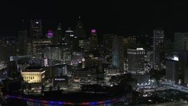 5.7K aerial stock footage of the city skyline at night, seen while flying by Comerica Park, Downtown Detroit, Michigan Aerial Stock Footage | DX0002_193_053