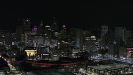 5.7K aerial stock footage fly past and away from Comerica Park and skyline at night, Downtown Detroit, Michigan Aerial Stock Footage | DX0002_193_055