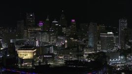5.7K aerial stock footage the downtown skyline seen from baseball stadium at night, Downtown Detroit, Michigan Aerial Stock Footage | DX0002_193_057