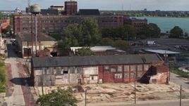 5.7K aerial stock footage ascend by an abandoned factory building in Detroit, Michigan Aerial Stock Footage | DX0002_194_021
