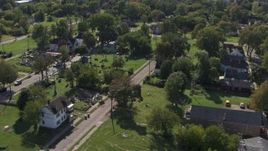 5.7K aerial stock footage of flying by the Heidelberg Project art display and urban homes in Detroit, Michigan Aerial Stock Footage | DX0002_195_006