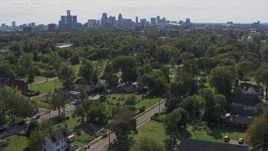 5.7K aerial stock footage of the skyline seen from the Heidelberg Project art display and urban homes in Detroit, Michigan Aerial Stock Footage | DX0002_195_007