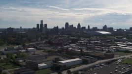 5.7K aerial stock footage wide view of the city's skyline seen from brick industrial buildings, Downtown Detroit, Michigan Aerial Stock Footage | DX0002_195_017