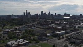 5.7K aerial stock footage of flying by the city's skyline, seen from brick industrial buildings, Downtown Detroit, Michigan Aerial Stock Footage | DX0002_195_021