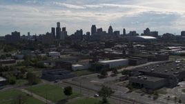 5.7K aerial stock footage of passing by the city's skyline, seen from brick industrial buildings, Downtown Detroit, Michigan Aerial Stock Footage | DX0002_195_022