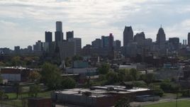 5.7K aerial stock footage focus on the city's skyline while descending near brick buildings, Downtown Detroit, Michigan Aerial Stock Footage | DX0002_195_024