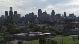 5.7K aerial stock footage focus on the city's skyline while ascending near brick buildings, Downtown Detroit, Michigan Aerial Stock Footage | DX0002_195_025