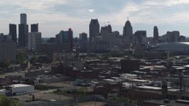 5.7K aerial stock footage focus on the city's skyline while flying past brick buildings, Downtown Detroit, Michigan Aerial Stock Footage | DX0002_195_027