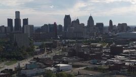 5.7K aerial stock footage focus on the city's skyline while flying past brick buildings, Downtown Detroit, Michigan Aerial Stock Footage | DX0002_195_028